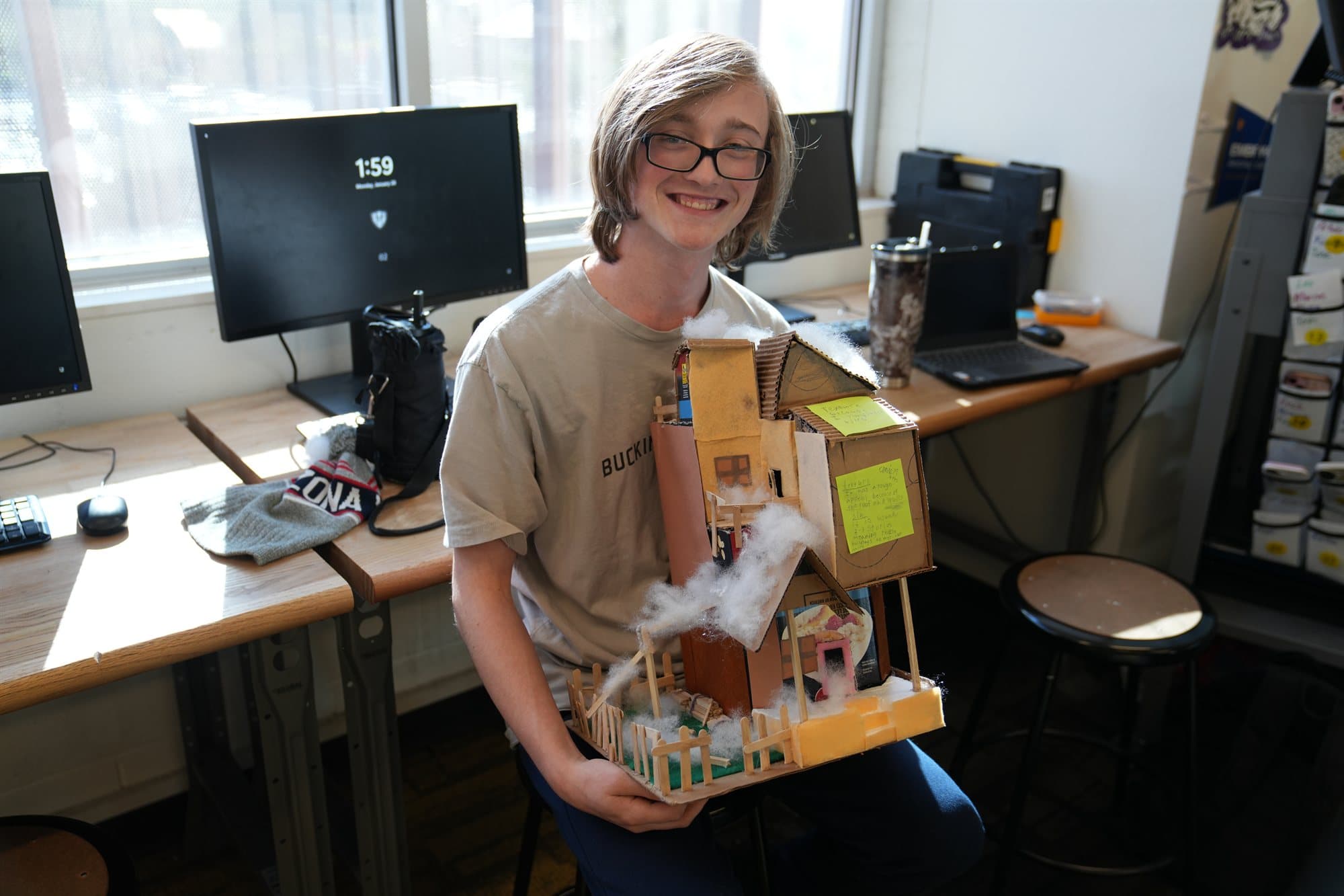 A Highland Prep student with a detailed architecture model