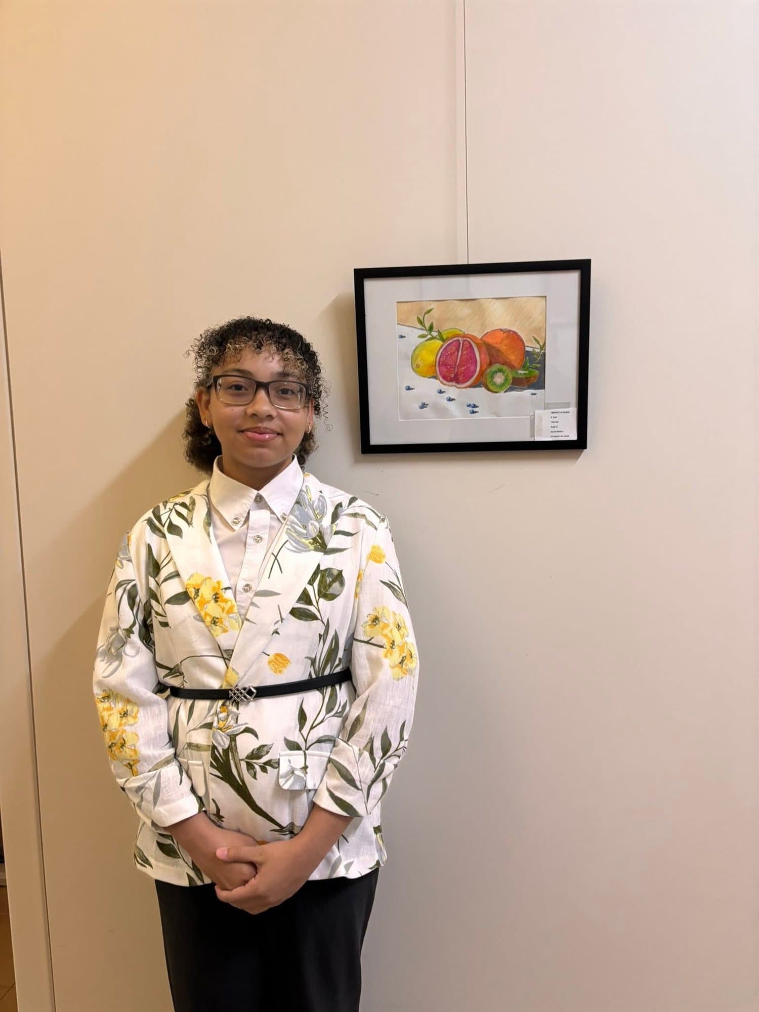 A Highland Prep student beside their framed still-life