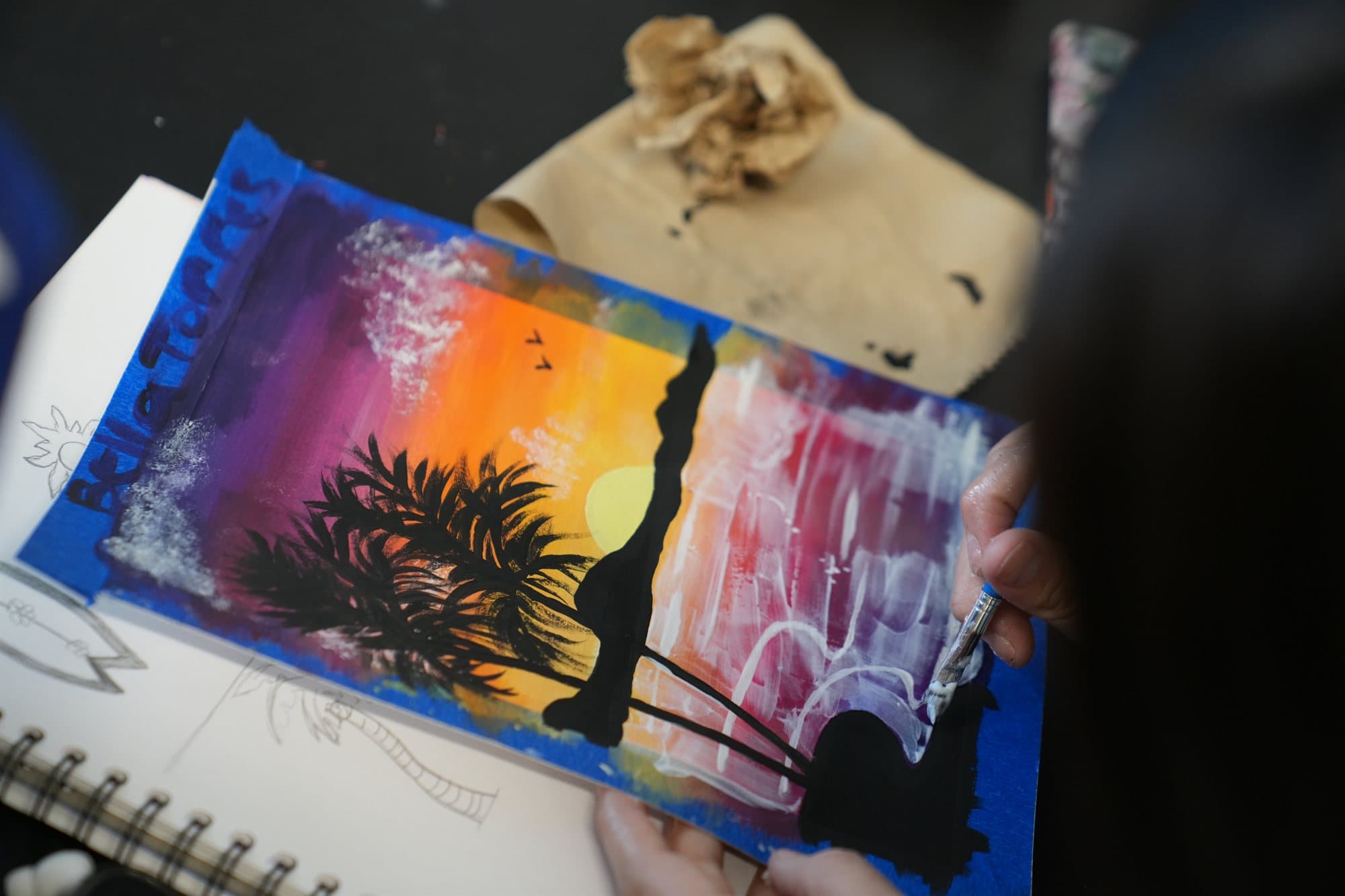 A Highland Prep art student painting a desert sunset