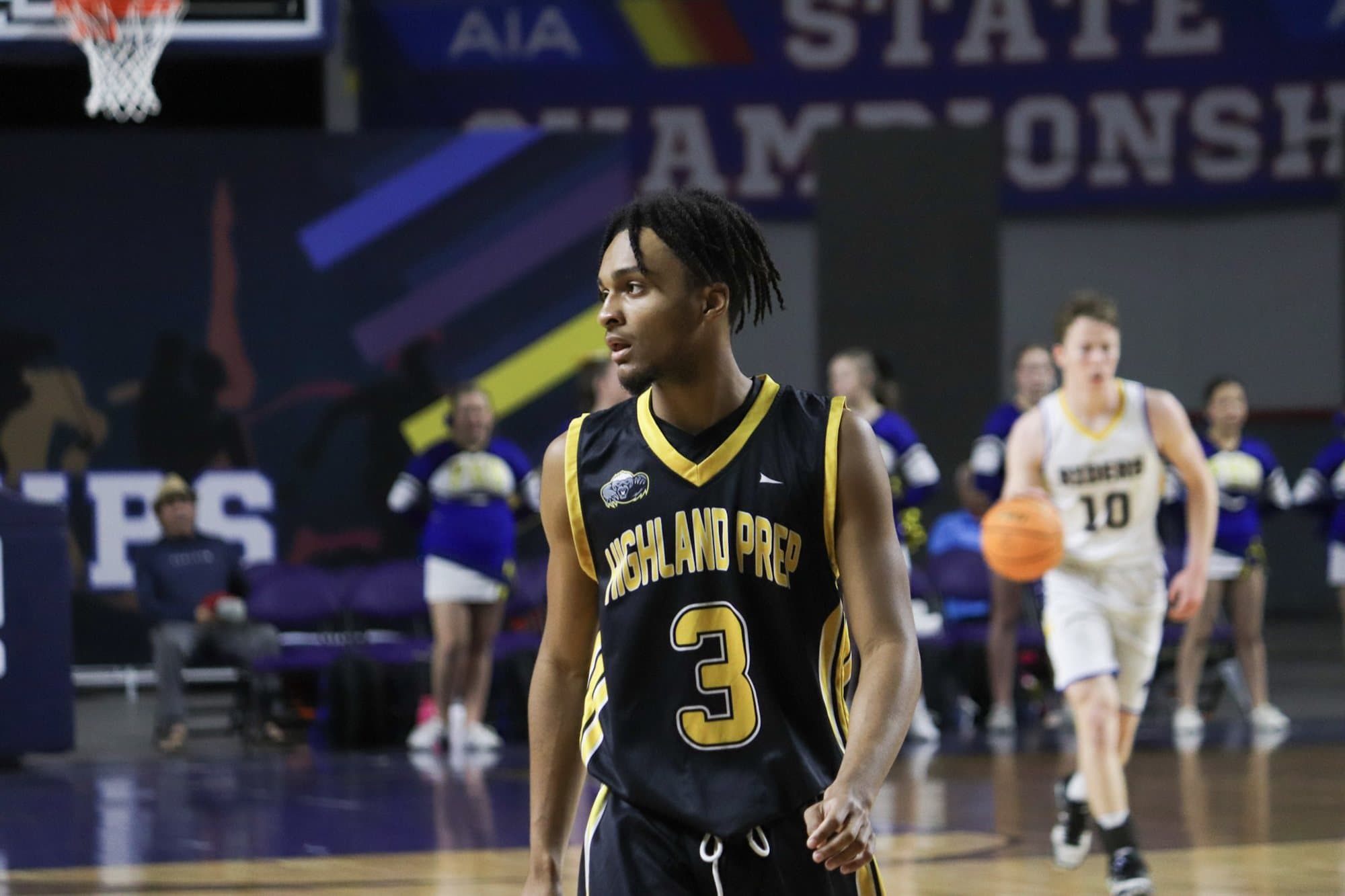A Highland Prep basketball player driving to the basket