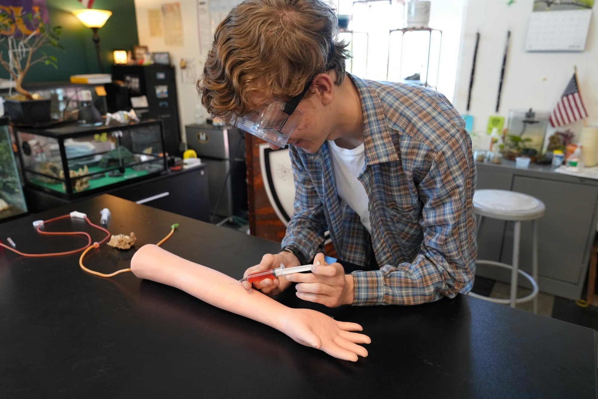 A Highland Prep biomedical science student building a model arm