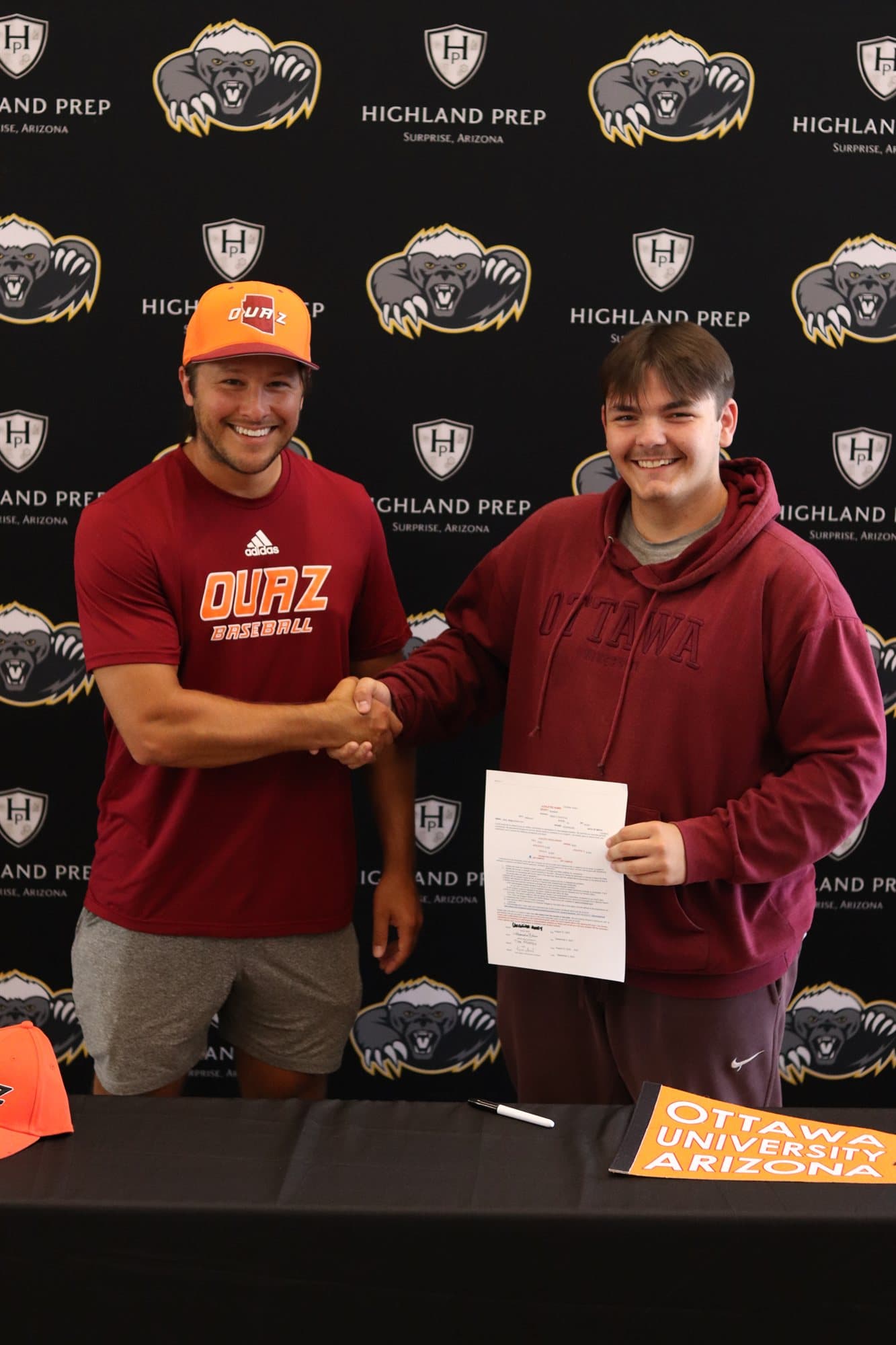 A Highland Prep senior at a college signing with their coach