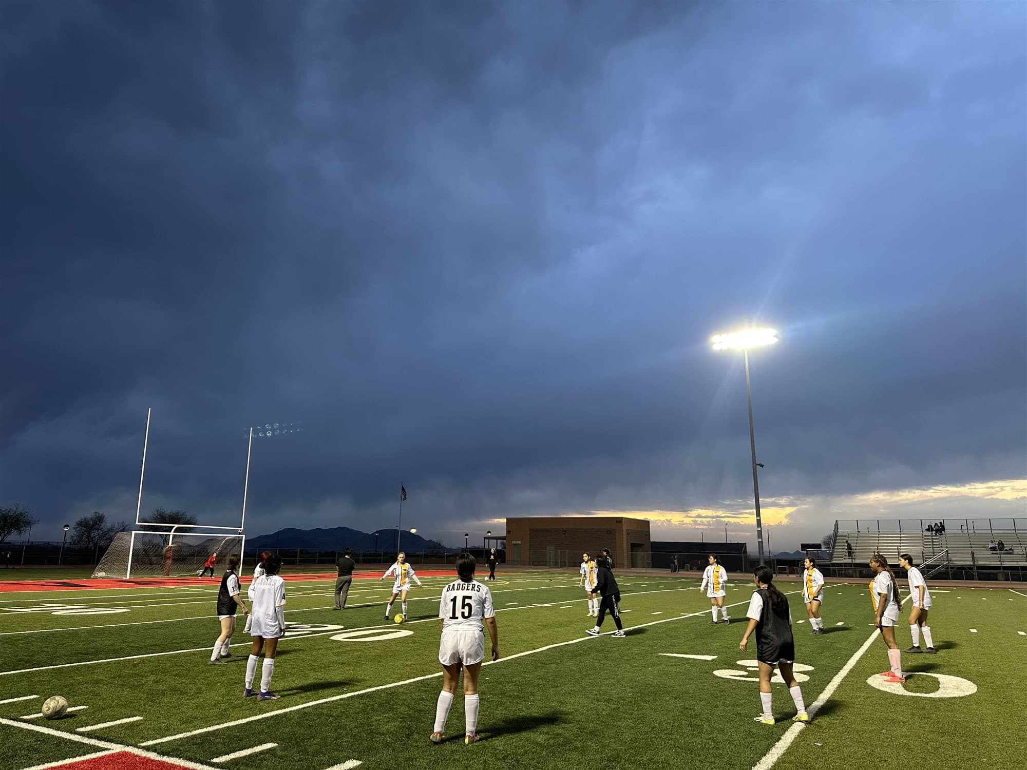 Highland Prep Honey Badgers on the field under the lights