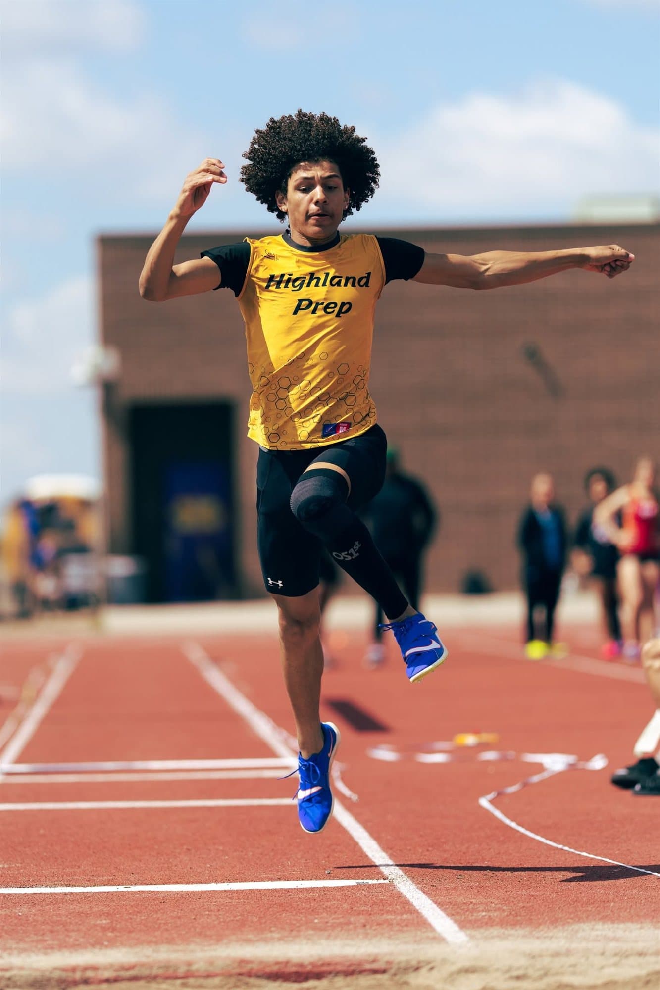 A Highland Prep long jumper in mid-air
