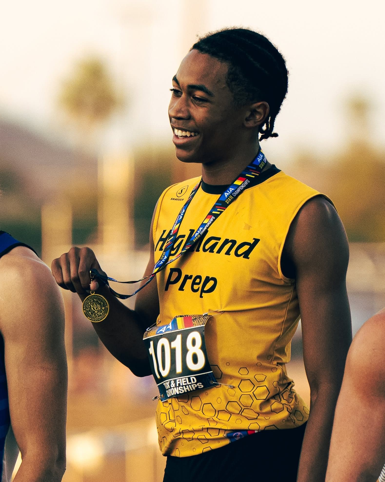 A Highland Prep track athlete with a gold medal
