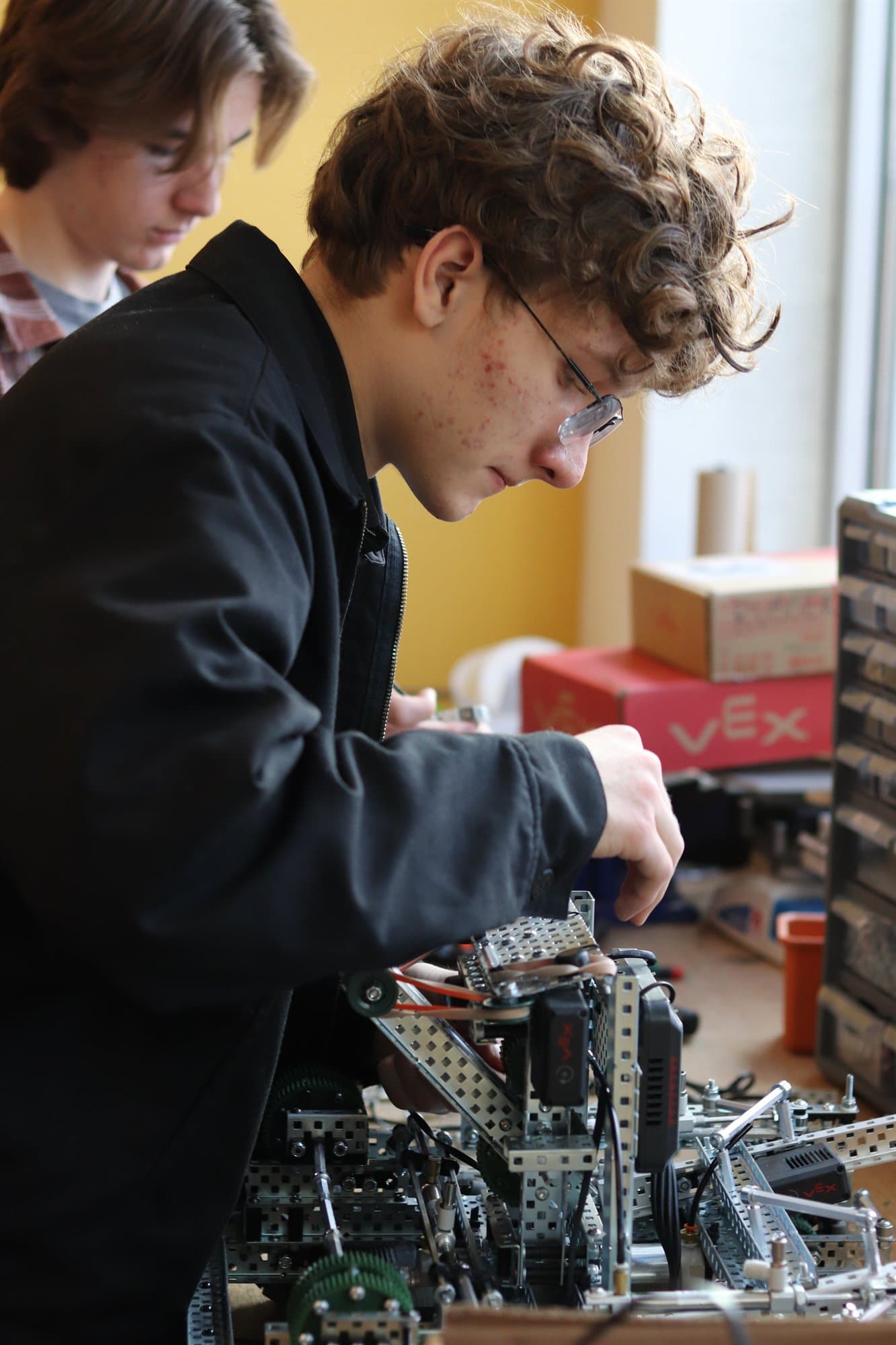 A Highland Prep student building and tuning a VEX competition robot